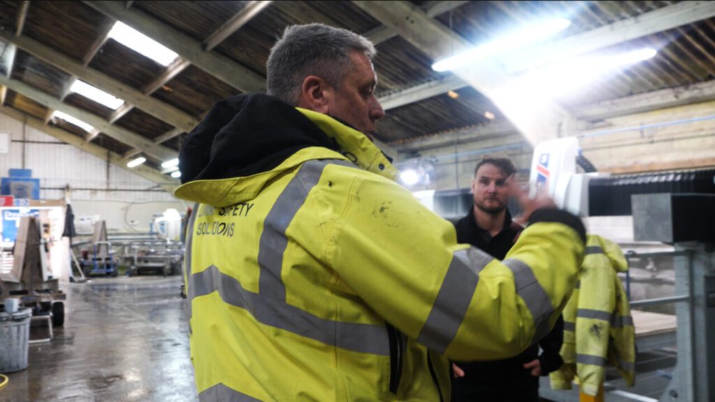 Managing director reviewing health and safety requirements with consultant